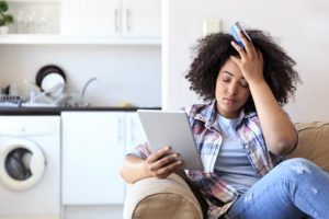 Consumer Loans - Girl paying bills and stressed
